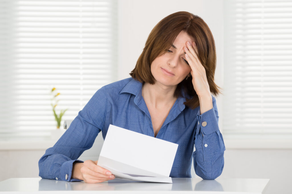 Woman reading non-renewal notice from insurance